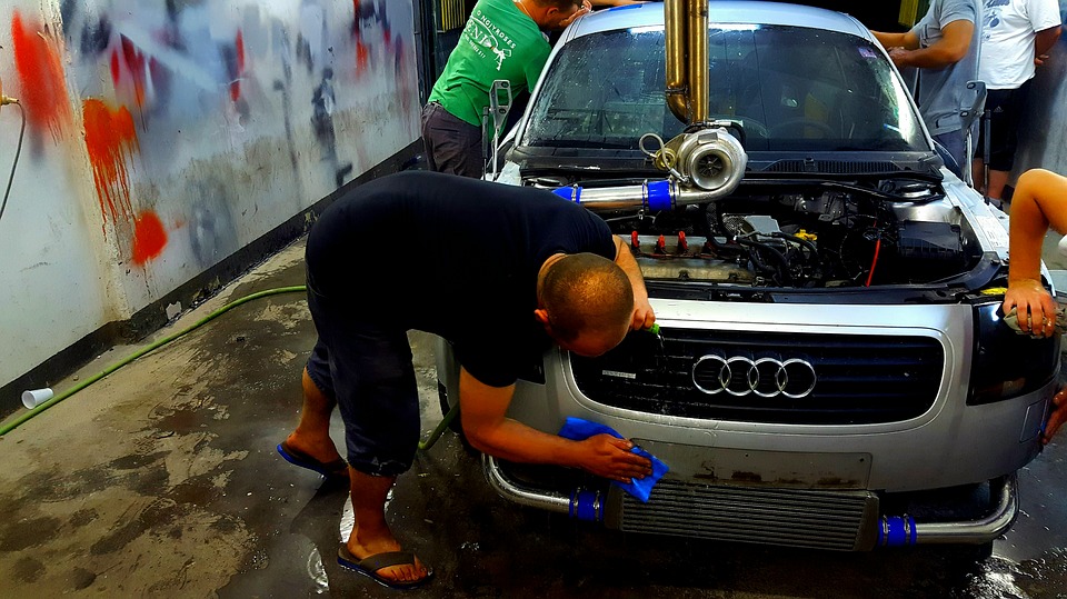 man fixing car